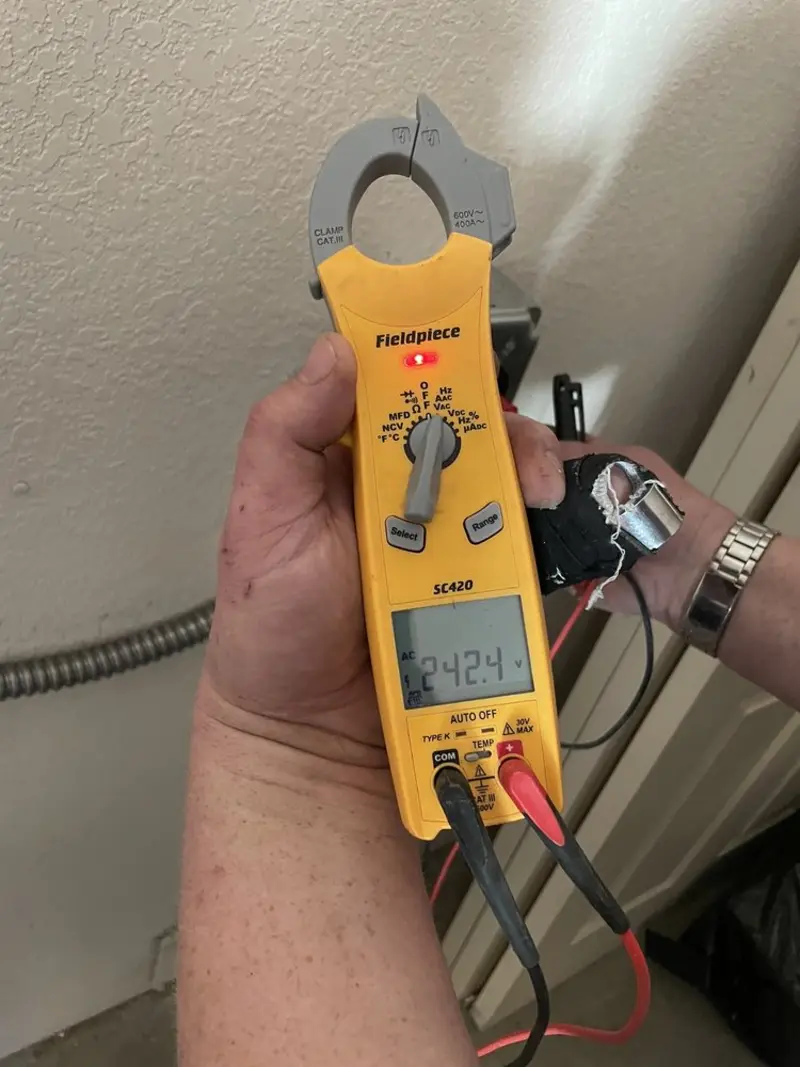 Voltage testing with clamp meter during Electrical Installation Services in Covington